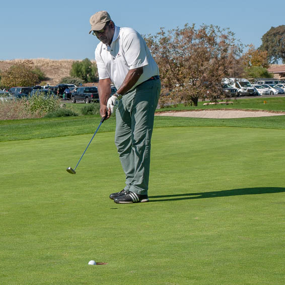 Person hitting golf ball