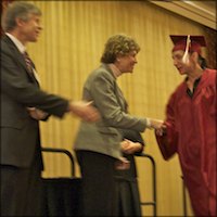 Graduate shaking hands with Board members