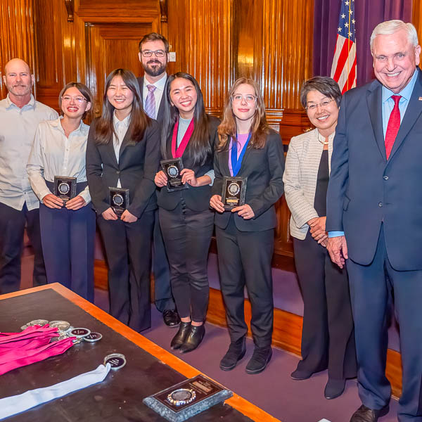 Bella Vista team holding plaques and posing with superintendent