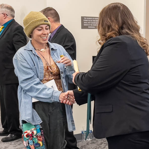 Graduate shaking hands with dignitaries