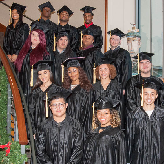 Graduates posing on staircase