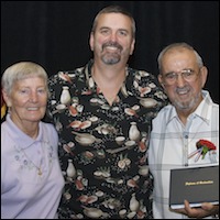 Graduate posing with family