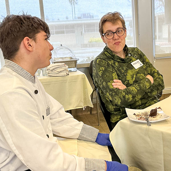 Student talking with visitor