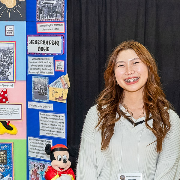 Smiling student posing with project
