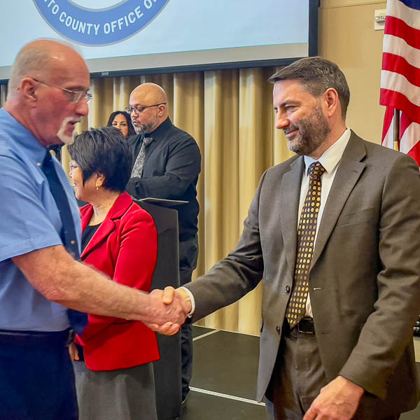 Michael Kast shaking hands with graduate
