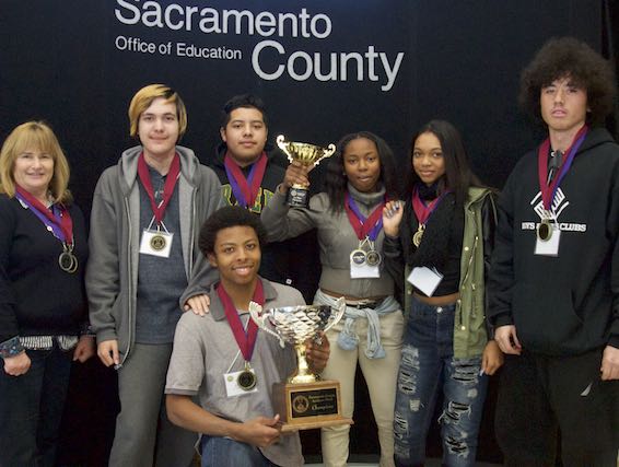 Academic Bowl team holding trophy