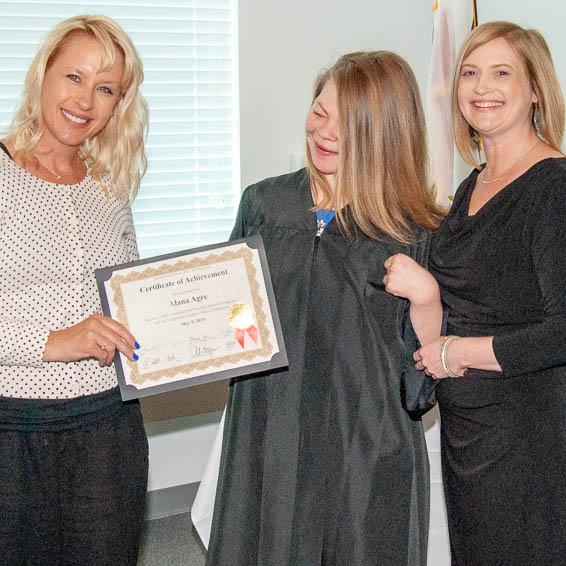 Board trustee presenting diploma