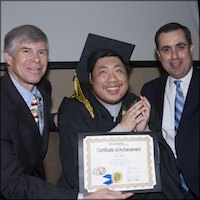 Board members presenting certificate to smiling student