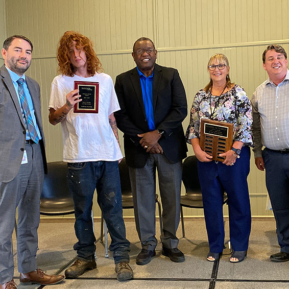 Anthony G. posing with dignitaries