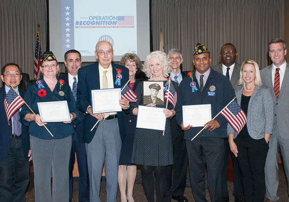 Diploma recipients posing with Board members