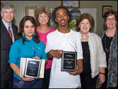 Students posing and holding plaques