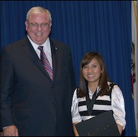 Student posing with superintendent