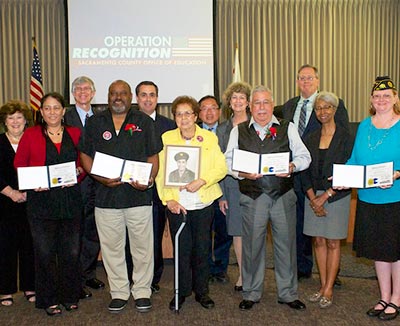 Graduates posing with Board of Education