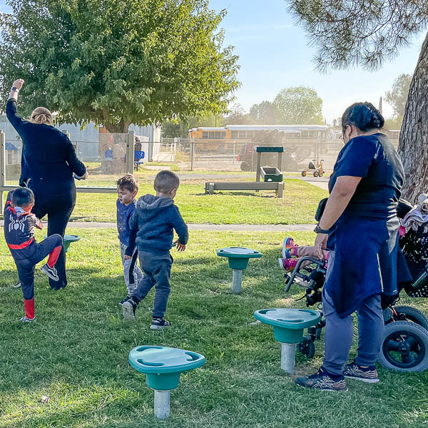 Child using a wheelchair plays with children on the playground