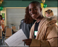 Smiling student holding paperwork