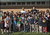 Group photo with students and NBA players outside school