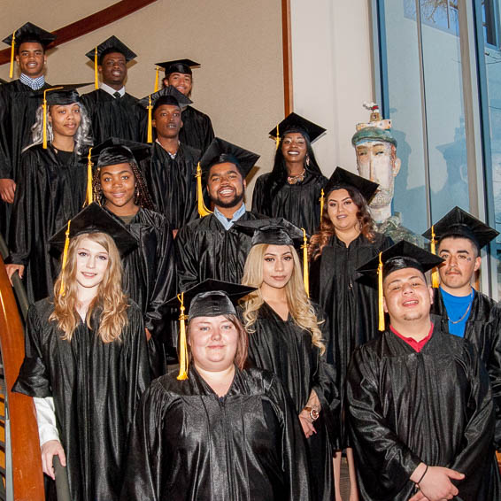 Graduates posing on stairs