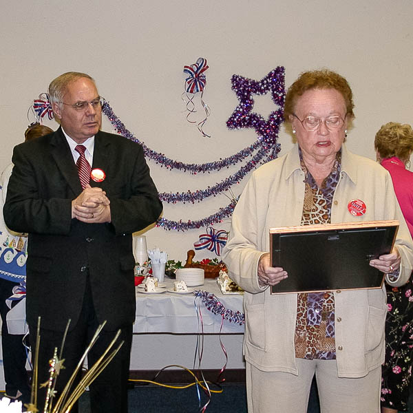 Elinor Hickey reading text of Board resolution with Superintendent Meaney looking on