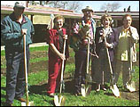 Group holding gold shovels