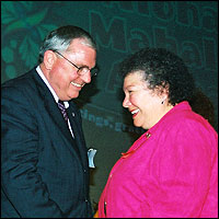 Superintendent congratulating smiling staff member