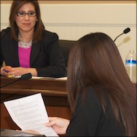 Nora Campos listening to student testimony