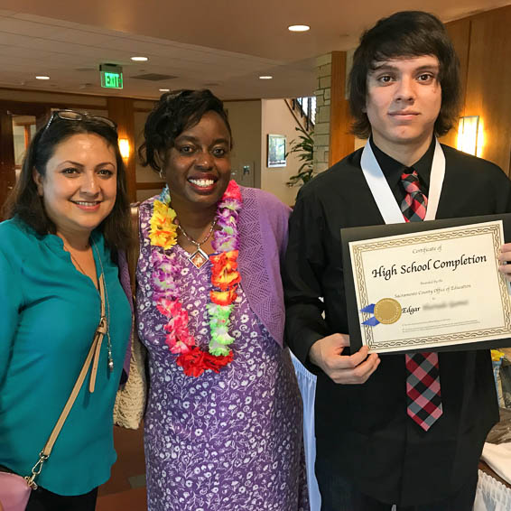 Student posing with certificate