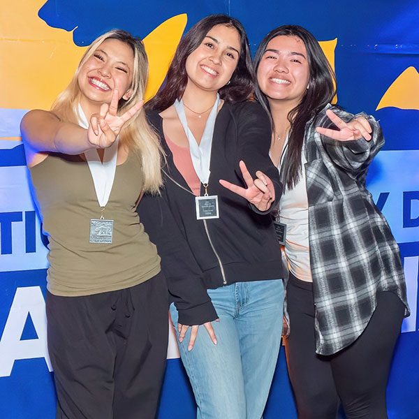 Group of students giving peace sign while posing