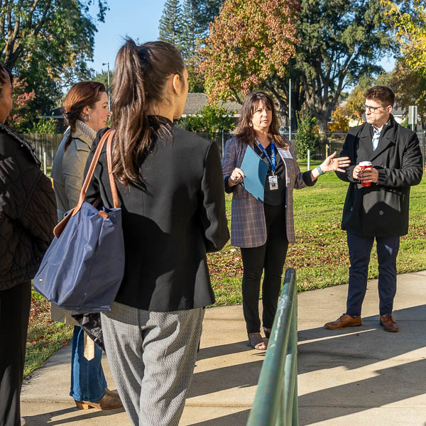 Julie Montali speaking to visitors outside the classroom