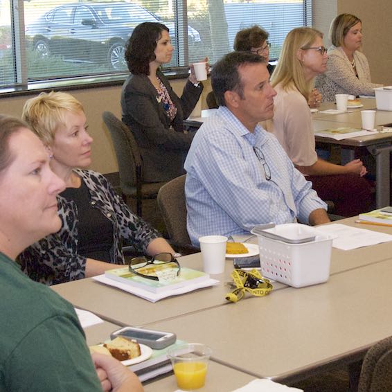 Seated audience members listening to speaker