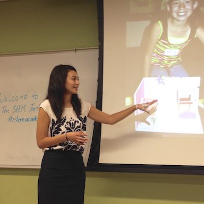 Instructor gesturing in front of projector screen