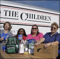 Staff holding school supplies