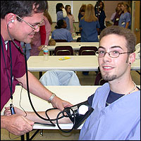 Student taking another student's blood pressure