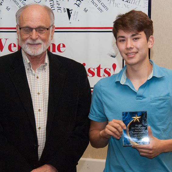 Walt Yost standing next to Kainoa Lowman holding plaque