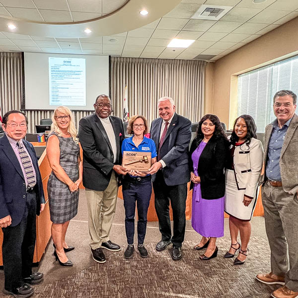 Board presenting plaque to Bina Lefkovitz