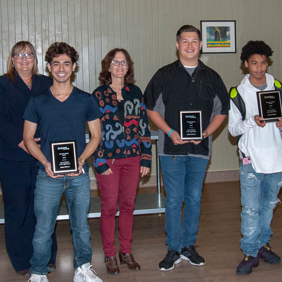 Students holding plaques