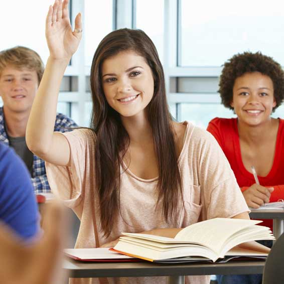 Student in classroom raising hand