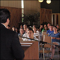 Audience listening to Atour Eyvasian speak