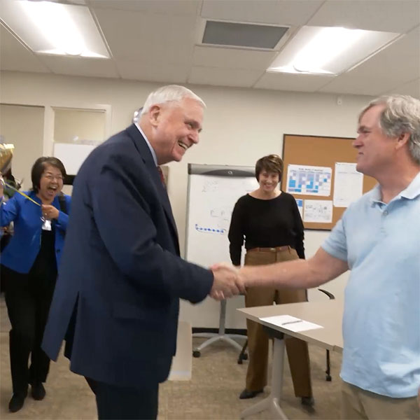 Superintendent Gordon shaking hands with Bill Garvey