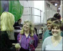 Smiling group of teachers in front of TV broadcast trailer