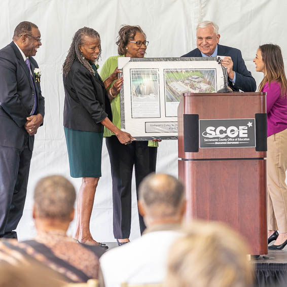 Family members receiving framed dedication keepsake