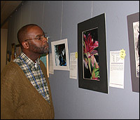 Staff member admiring student artwork hanging in the halls of SCOE