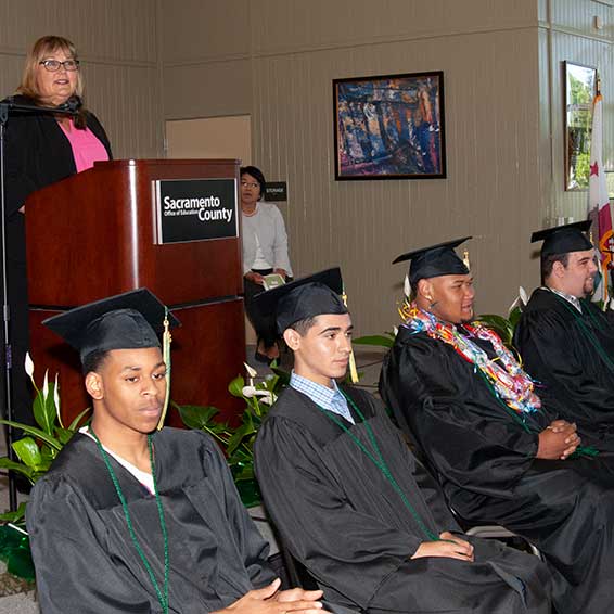 Graduates seated in front of speaker