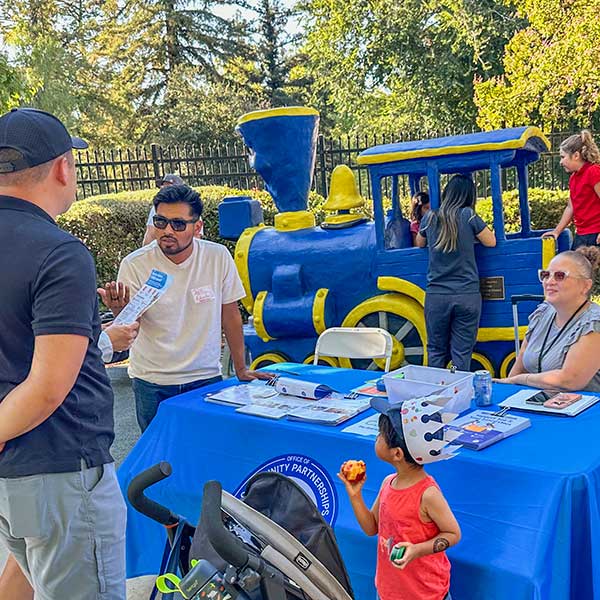 Family receiving information at booth