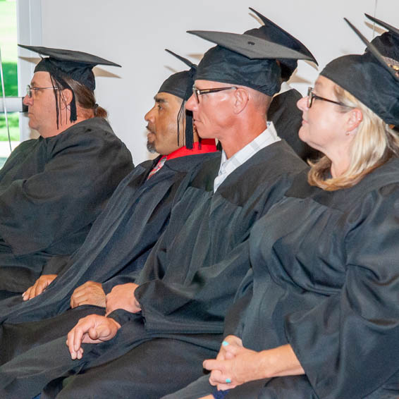 Seated certificate recipients smiling