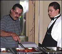 Culinary student helping serve food