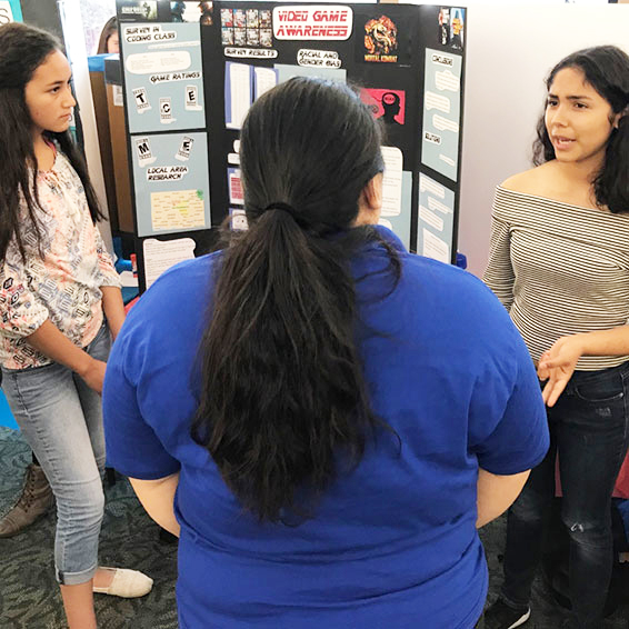 Students discussing 'Video Game Awareness' project