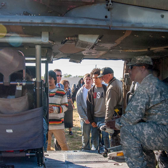 Students looking through door of helicopter