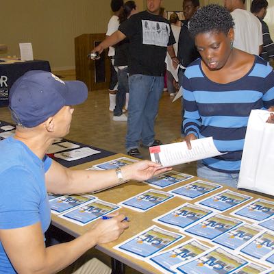 Student picking up a brochure