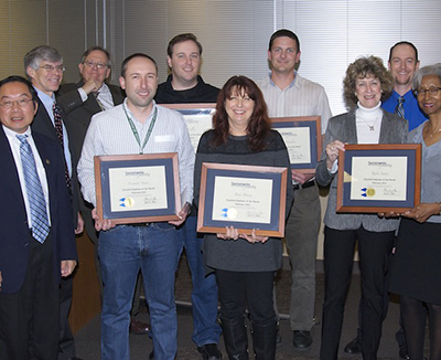 Fernando Soares, Bill Mullen, Betsy Bourne, and Scott Pantalone receiving certificates.