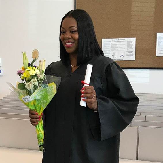 Female graduate holding flowers and rolled diploma